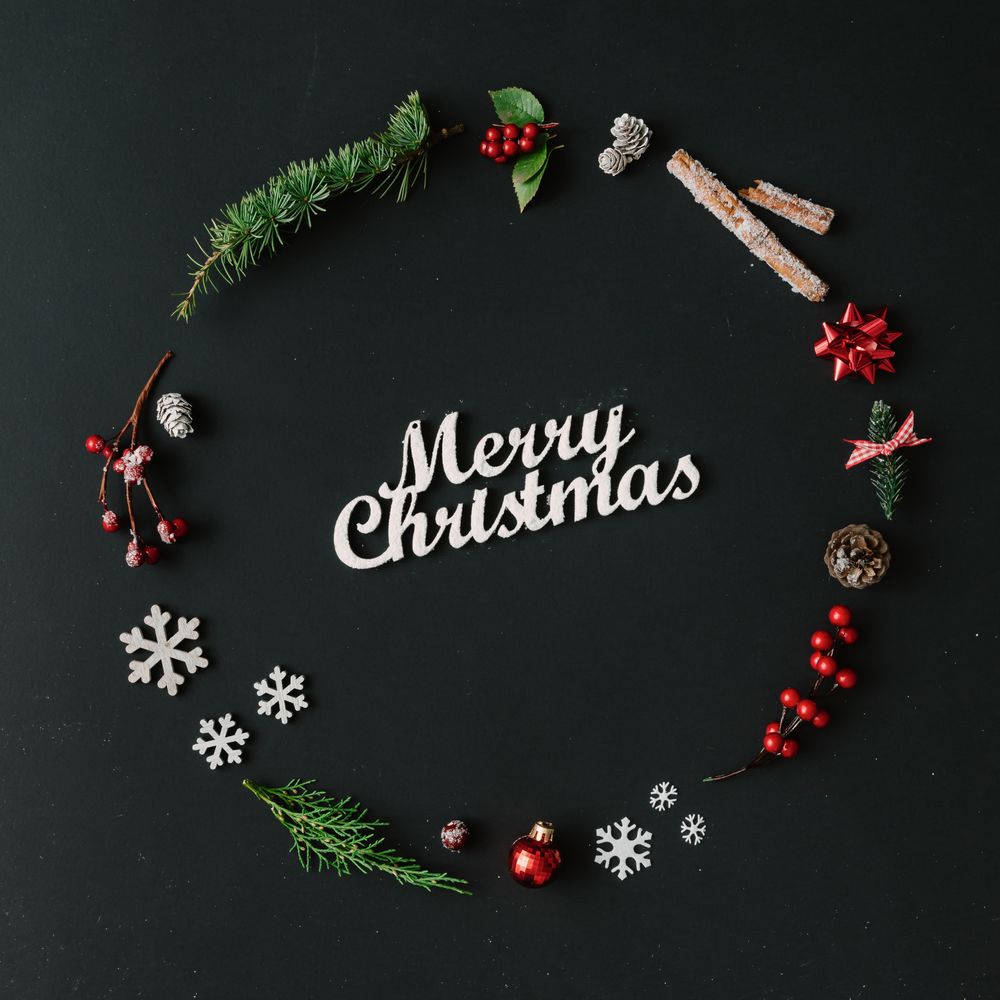 Christmas wreath made of winter items on dark background