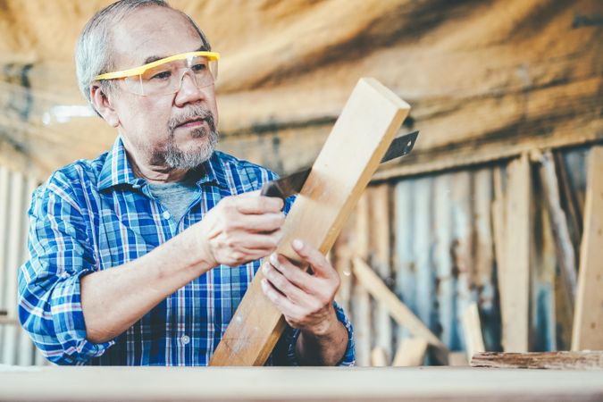Mature man working in carpentry shop