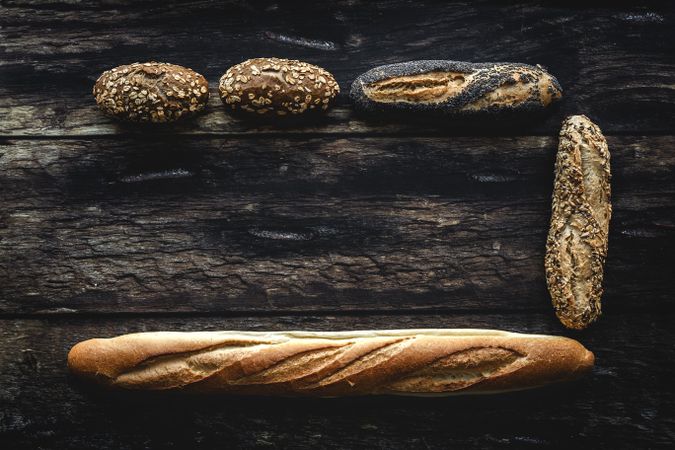 Assorted gold homemade bread on dark wood background