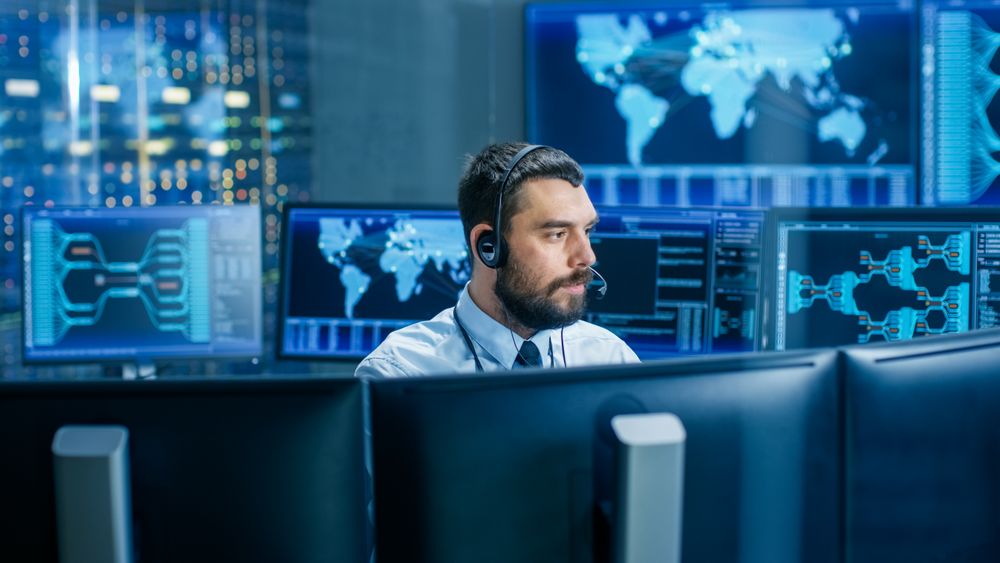 System Control Room Dispatcher Talks into Headset.