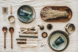 Vintage kitchen utensils artfully arranged on beige tablecloth