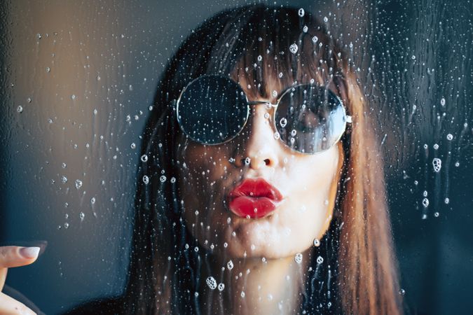 Stylish woman kissing glass