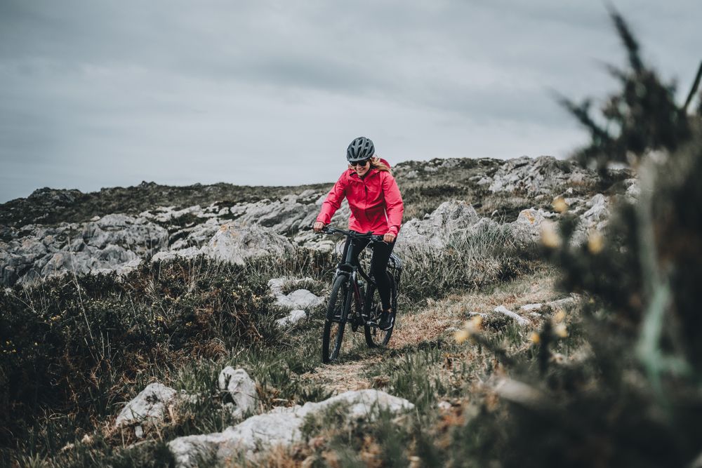 Female riding bicycle on countryside