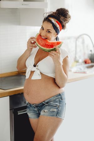 Pregnant female eating delicious watermelon
