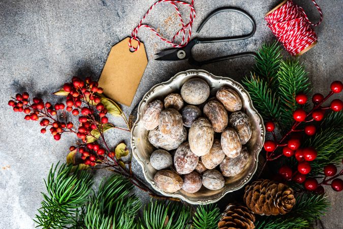 Top view of bowl of walnuts on table with Christmas scene