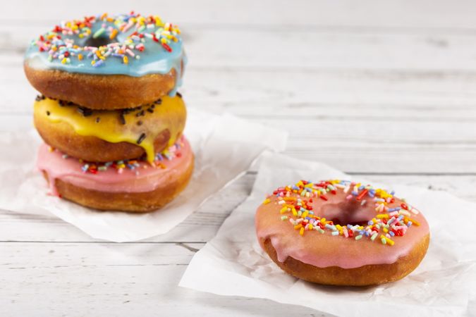 Delicious assorted colorful donuts on the table.
