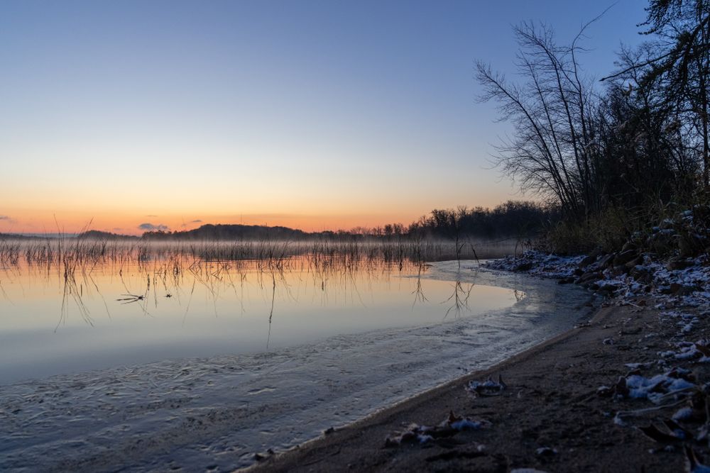 Sunrise and icy edges on Big Sandy Lake in McGregor, Minnesota