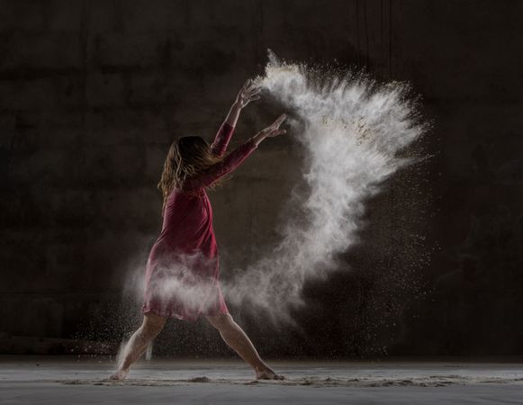 Young woman between fog in darkness