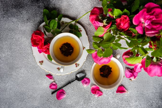 Top view of tea set with red roses and copy space