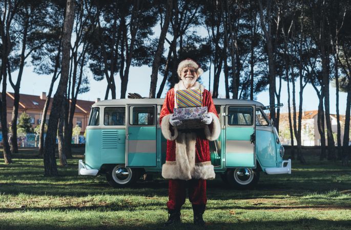 Santa Claus with presents by old van