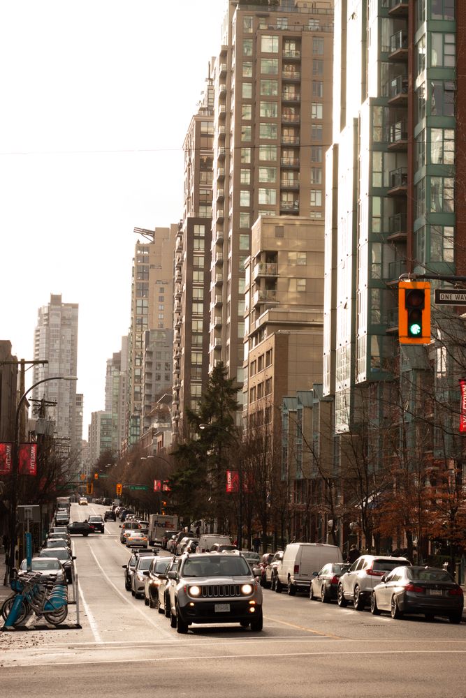 Cars on road near high rise buildings