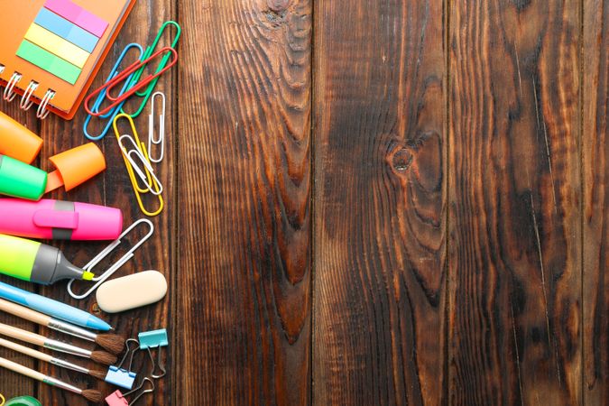 Flat lay composition with school supplies on wooden background, space for text