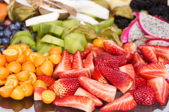 assorted fruits strawberries kiwi grape coconut coconut berries pumpkin dragon fruit