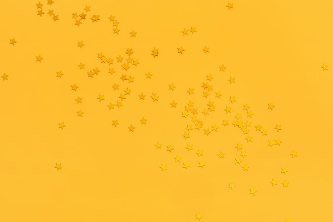 Golden stars on vibrant yellow background