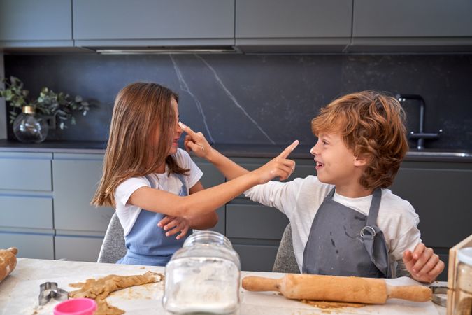 Smiling boy and girl bonding while cooking