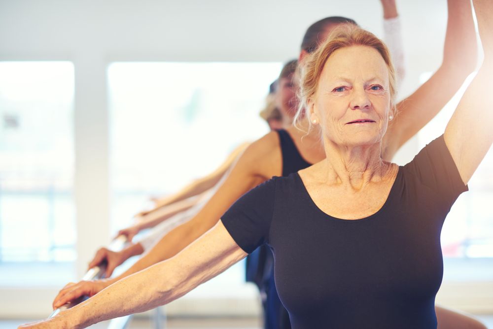 Portrait of women posing at barre class