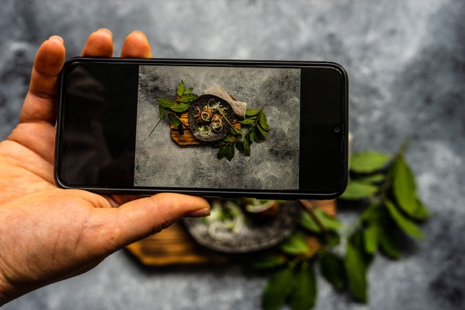 Traditional Georgian food - abkhazura cutlet being photographed on phone screen
