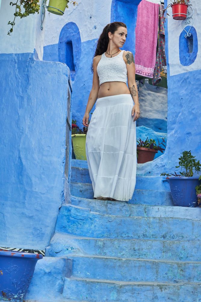 Woman on steps between ancient buildings