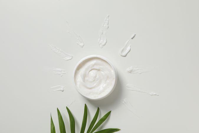 Cream jar on light background, top view