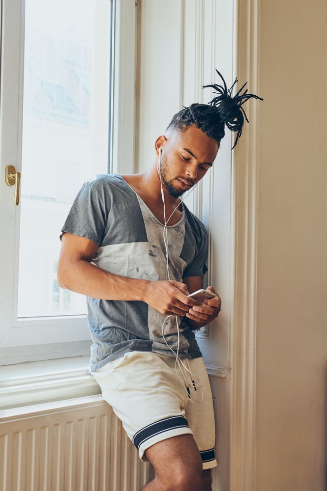 Cheerful Black male listening to music