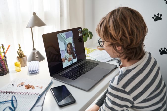 Boy making video call with classmate