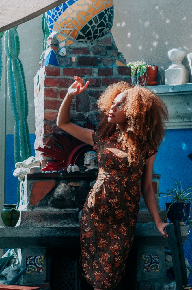 Woman with natural hair shields her eyes from the sun