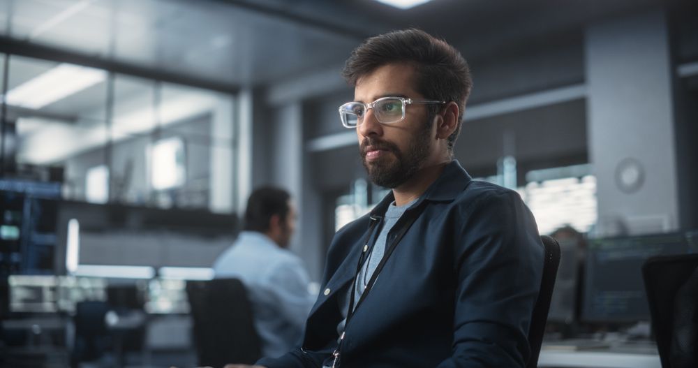 Indian Software Developer Working on Computer in a Technological Laboratory Environment.