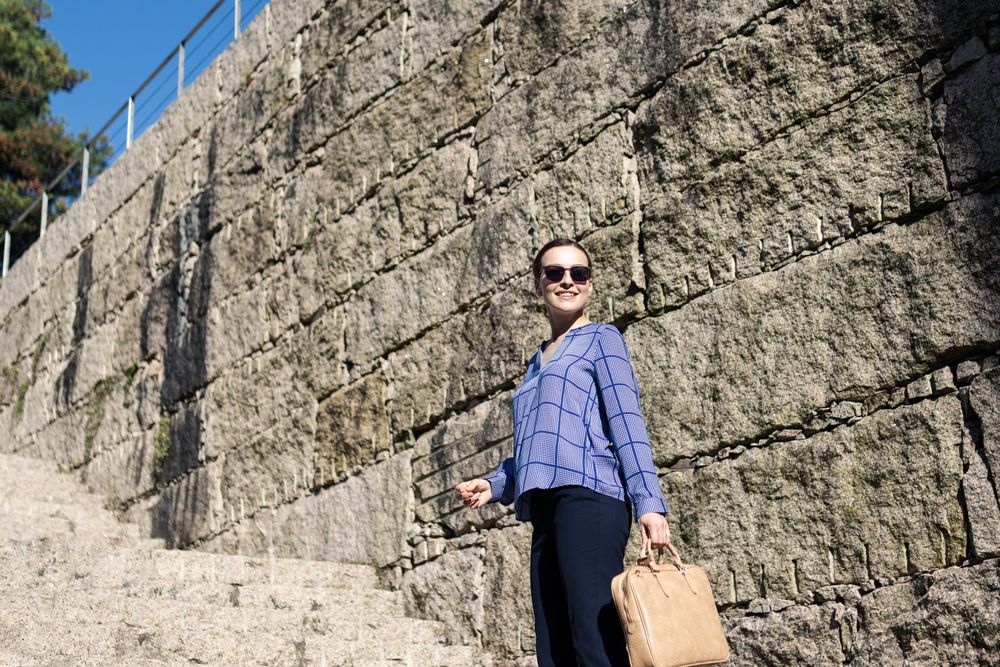 Businesswoman climbing up street stairs