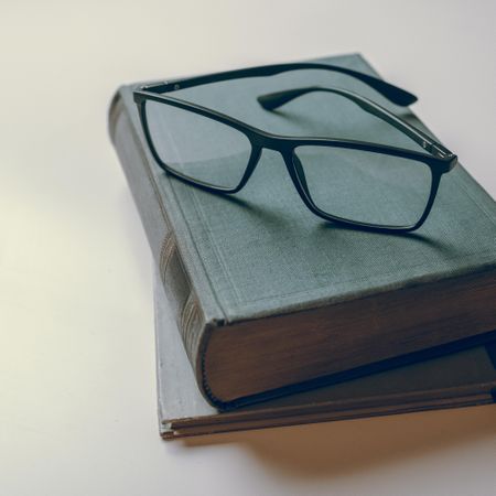 Eyeglasses resting on books