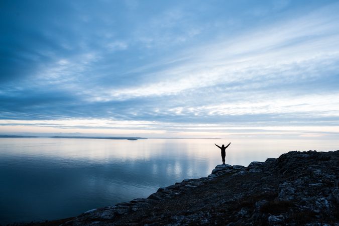 Happy man on rocky coastline