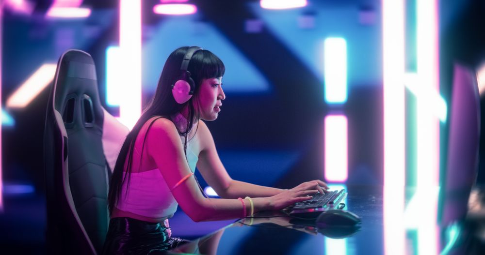 Japanese Female Gamer Playing Online Video Game on Computer.