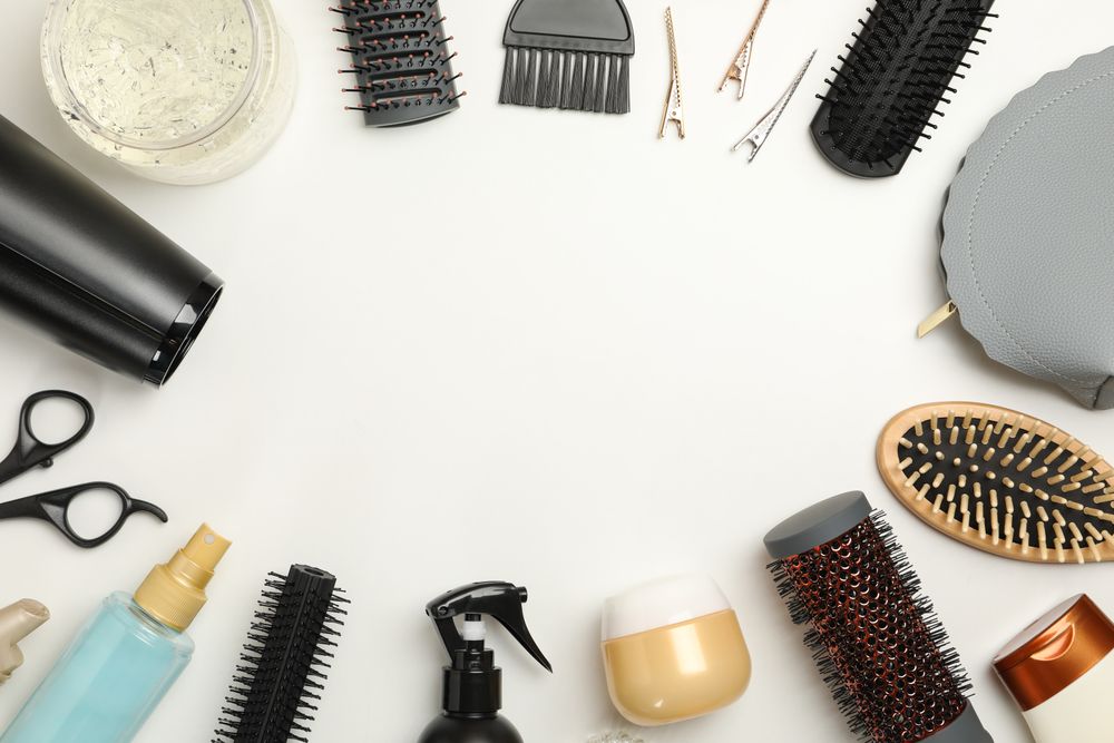 Composition with hairdresser accessories on plain background, space for text