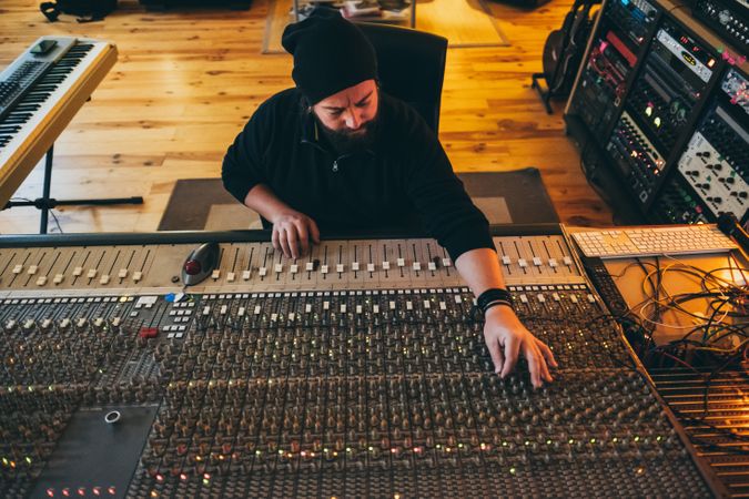 Man in a equalizer instrument in a studio