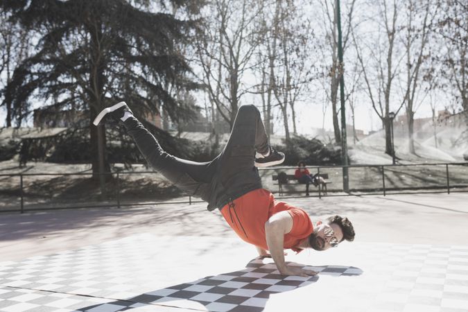 Man dancing break dance in park