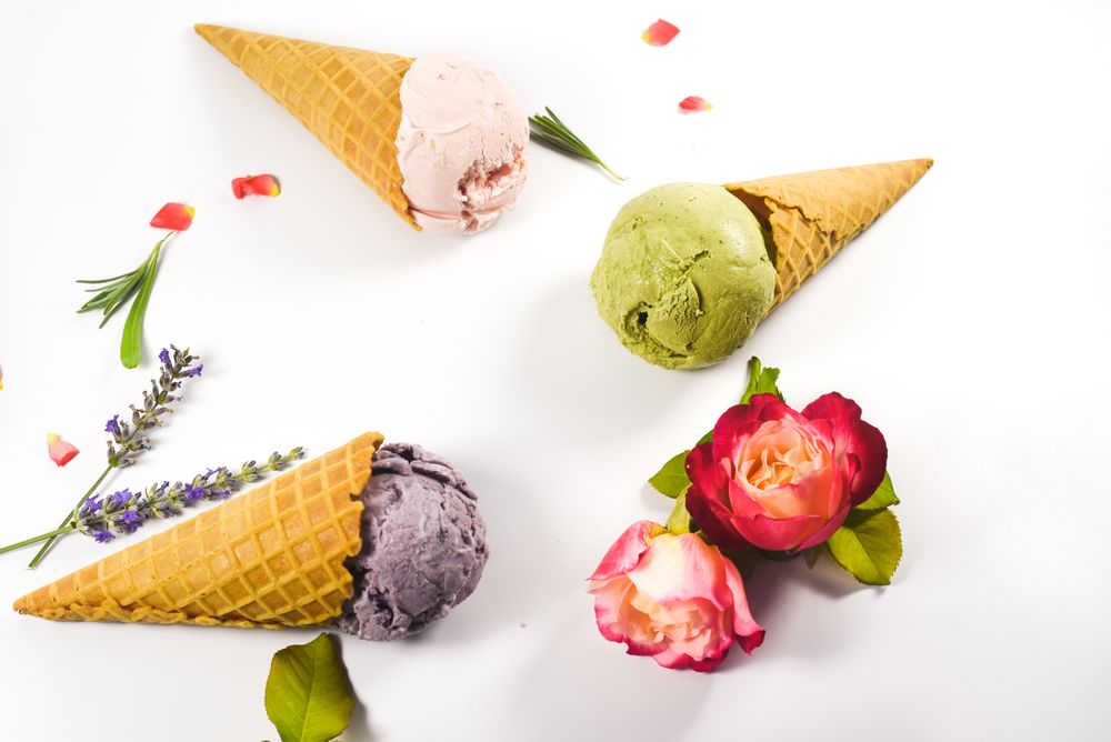 Three waffle cones with different ice cream scoops