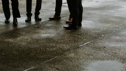 Cropped image of men in formal shoes standing on asphalt road 47qJk0