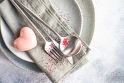 Grey themed table setting for Valentine's day with pink heart