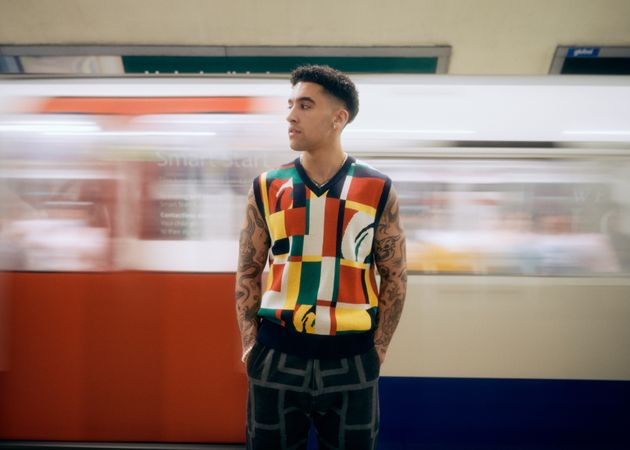Male standing in London Underground with trail in motion behind