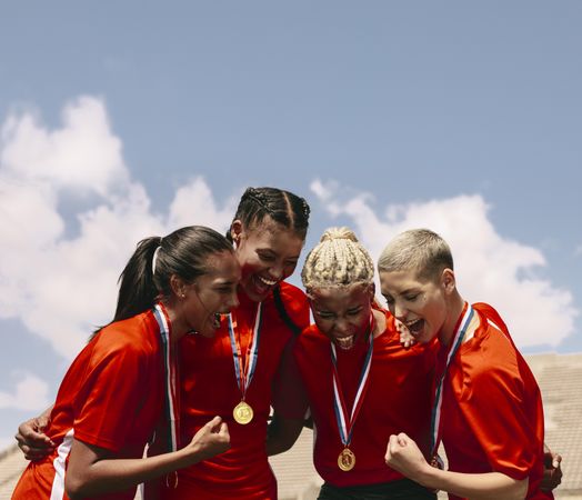 Woman football team with medals celebrating victory