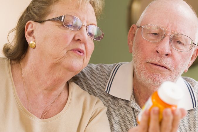 Couple Reading Medicine Bottle