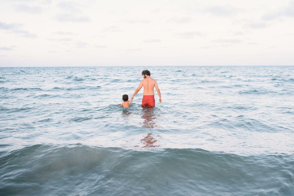 Father with son walking in water