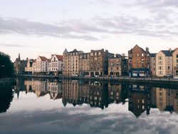 Buildings along a canal in late afternoon sunshine