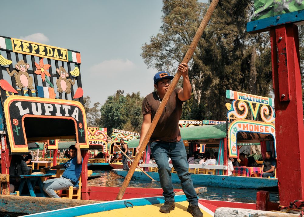 Man steering colorful tourist boat in Mexico