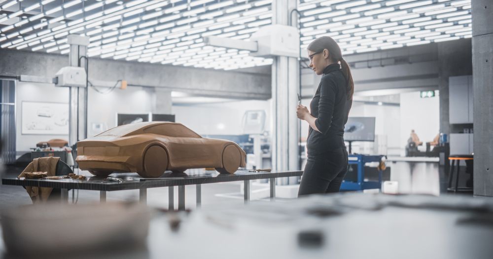 Female Designer Working on a Prototype, Sculpting Industrial Plasticine Clay 3D Model of Sport Coupe
