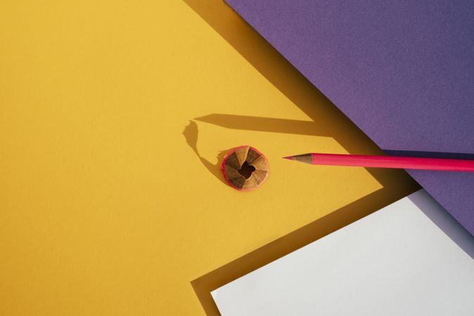 Back to school: Pink pencil on geometric background