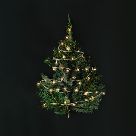 Christmas tree with lights on dark table top