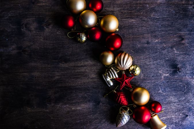 Red & Golden Christmas baubles on wooden table
