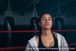 Confident female boxer standing in the ring in hoodie 5zrQpA