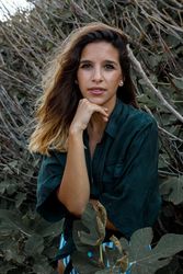 Tranquil woman in stylish clothing delighting in forest