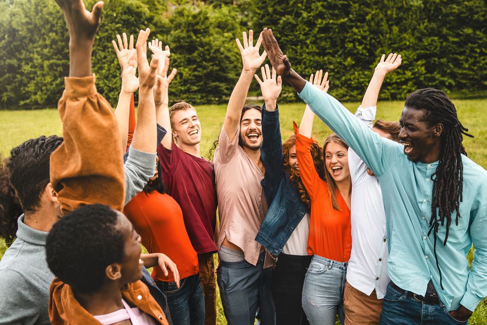 Multi-ethnic friends celebrating outdoors in park